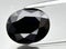 natural black spinel gem on the background