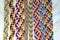Natural bracelets of friendship, colorful woven friendship bracelets, snow background, rainbow colors, checkered pattern