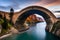 A natural bridge spanning a narrow river gorge, created by the relentless forces of water and time