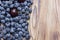 Natural bright background of natural fresh ripe blueberries and cherries on a brushed wooden table