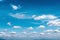 Natural bright blue sky background and white clouds group pattern floating with light wind in summer day