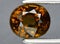 Natural brown grossular garnet gem on the background