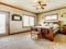 Natural cabin farm house bedroom with beige carpet and green walls.