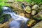 Natural cascade water flows over the rocks to the lake, Portugal