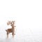 Natural christmas decoration with an isolated deer on white snow