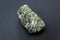 Natural chrysolite, olivine green color transparent raw crystal, close up