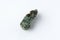 Natural chrysolite, olivine green color transparent raw crystal, close up, white background