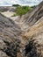 Natural clay quarry. Clay mountains and green trees