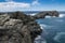 Natural coastal rock surface with cloudy sky and blue ocean water in Kiama, New South Wales, Australia.