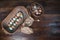 Natural colored eggs in antique dough bowl and basket on a wooden tabletop.