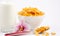 Natural corn flake breakfast cereal in cups and milk is a healthy breakfast that is good for your body every day on a white