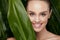 Natural Cosmetics. Beautiful Woman Face With Green Plant