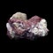 Natural crude pink tourmaline rubellite in rock on black background