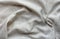 Natural crumpled linen fabric, textile background