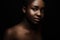 Natural dark bronze portrait of beautiful african woman on black bakground