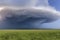 Natural Disasters, tornados, threatening dark tornado forming cloud over grassland, created with Generative AI