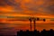 Natural dramatic with clouds colorful urban sunset with construction crane