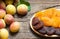 Natural dried apricots in bamboo bowl with Fresh whole Ripe apricot on wooden rustic backdrop