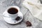 Natural drink chicory in a white Cup and saucer on a marble table with pieces of chocolate