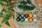 Natural dye easter eggs in carton tray on rustic table with flowers. Modern yellow, pink, blue and grey easter eggs painted with