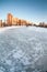 Natural empty ice rink on frozen lake in sleeping quarters of the St. Petersburg at winter season. Russia