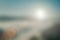 Natural fog and mountains sunlight background blurring, misty waves warm colors and bright sun light. Christmas background sky