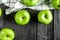 Natural food design with green apples dark desk background top view