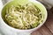 Natural food: raw zucchini pasta in a bowl closeup. horizontal