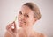 Natural and fresh. Cropped portrait of a beautiful mature woman posing with a piece of cucumber.