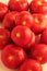 Natural,fresh field tomatoes heap on the white surface