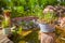 Natural garden with small patio, native plants, natural stones, pond and potted plants