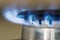 Natural gas blue flames burns on the kitchen stove hob, close up