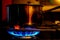 Natural gas burner at a cabin kitchen heating up a metal pot.