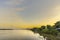 Natural gas electric power plant with smokestack at riverside in chonburi thailand and beautiful golden sunrise sky in morning