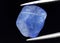 Natural gemstone blue tanzanite on gray background