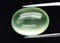 Natural gemstone green prehnite on gray background