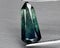 Natural gemstone green sapphire on gray background