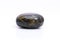 Natural gemstone labradorite isolated on white background. Dark gray labradorite with an inner iridescent glow on a