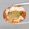 Natural gemstone orange Padparadscha sapphire on gray background