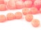 Natural gemstone pink coral beads on a white background