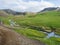 Natural geothermal bath in a Hot River stream in Reykjadalur Valley with wooden footpath and changing rooms. South