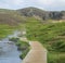 Natural geothermal bath in a Hot River stream in Reykjadalur Valley with wooden footpath and changing rooms. South Iceland near