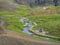 Natural geothermal bath in a Hot River stream in Reykjadalur Valley with wooden footpath and changing rooms. South Iceland near