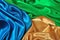 Natural golden, blue and green satin fabric texture