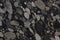 Natural granite with different pebbles in black and gray shades of color is called Nero Marinace