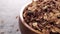 Natural granola with chocolate chips and wheat germ in wooden bowl.