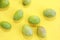 Natural green fresh olives on a yellow background