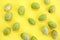 Natural green fresh olives on a yellow background