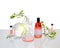 Natural Green laboratory. Abstract floral design. Orange liquid product, fragrance, perfume in glass bottle. Reflections