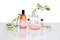 Natural Green laboratory. Abstract floral design. Orange liquid product, fragrance, perfume in transparent bottle